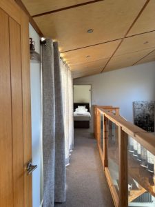 willow lodge view along landing to the triple bedroom